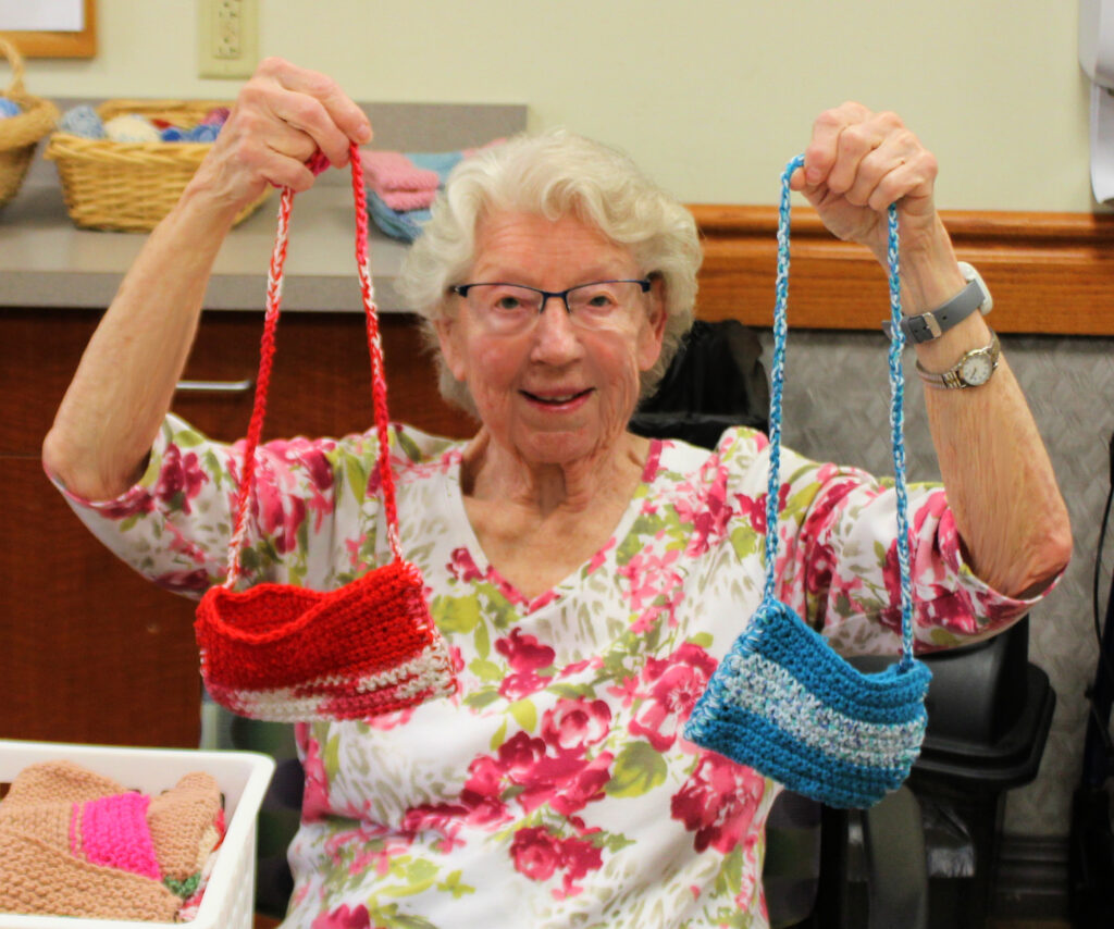 woman holding up two soap sacks