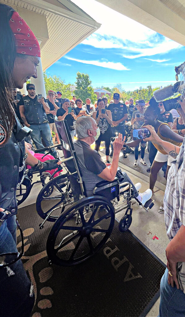 people clapping for man in wheelchair