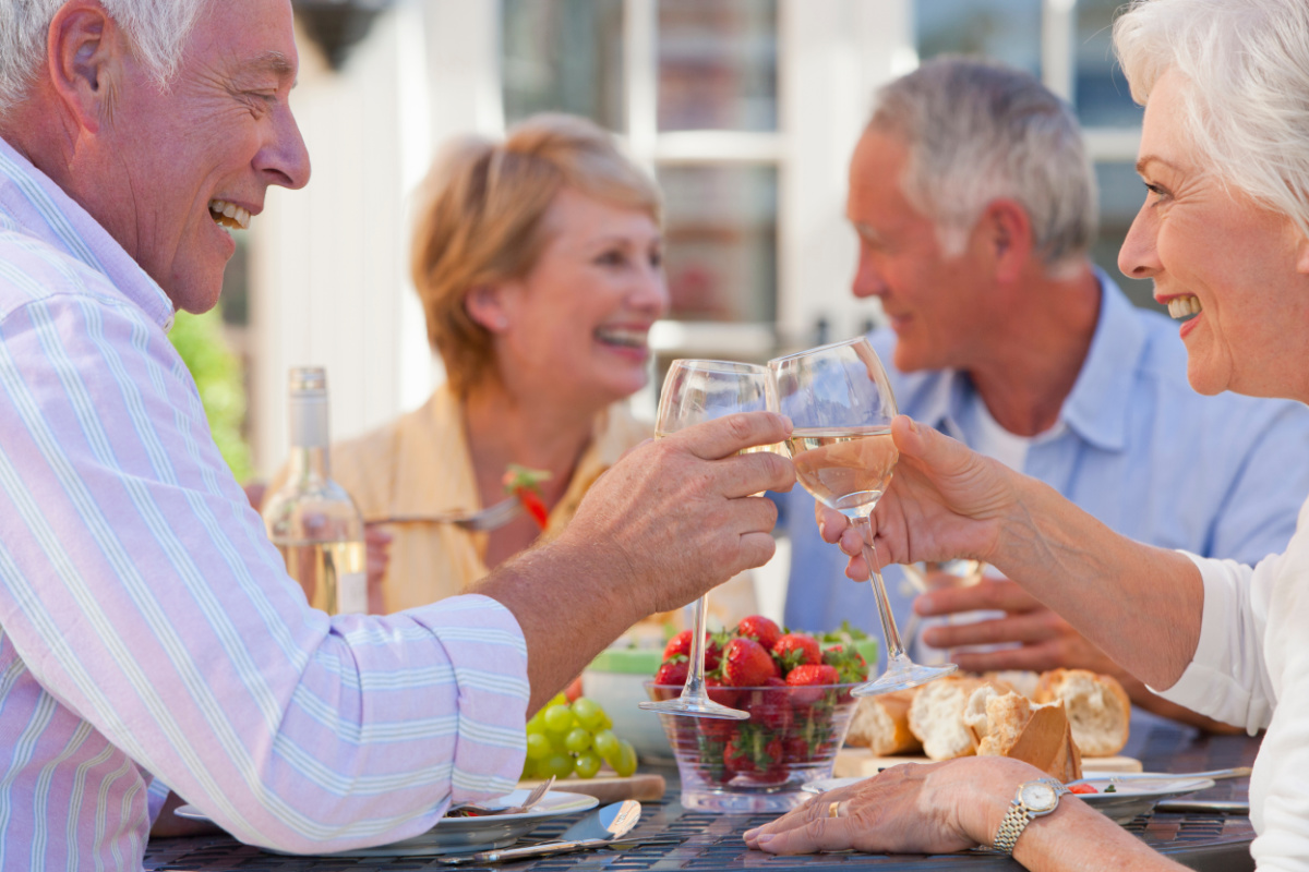 couples toasting wine glasses