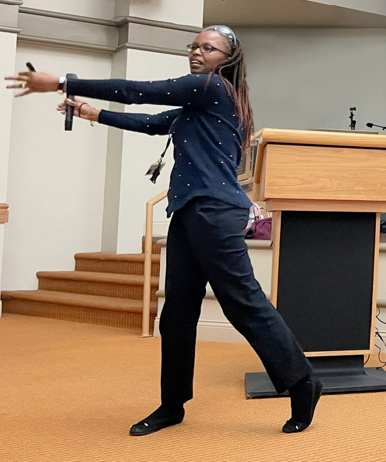 woman demonstrating in front of podium