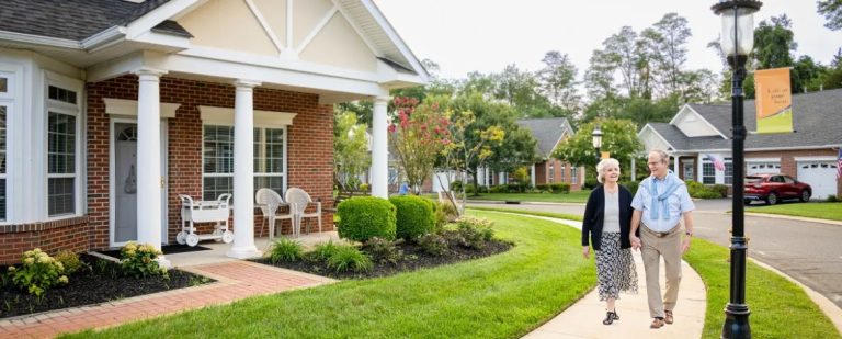 couple walking by cottage