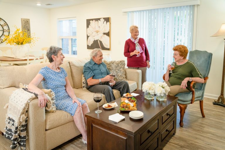 four people snacking in living room