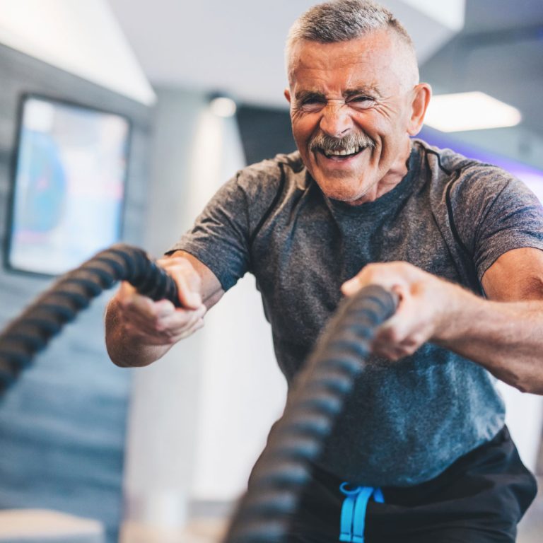 man in gym on ropes