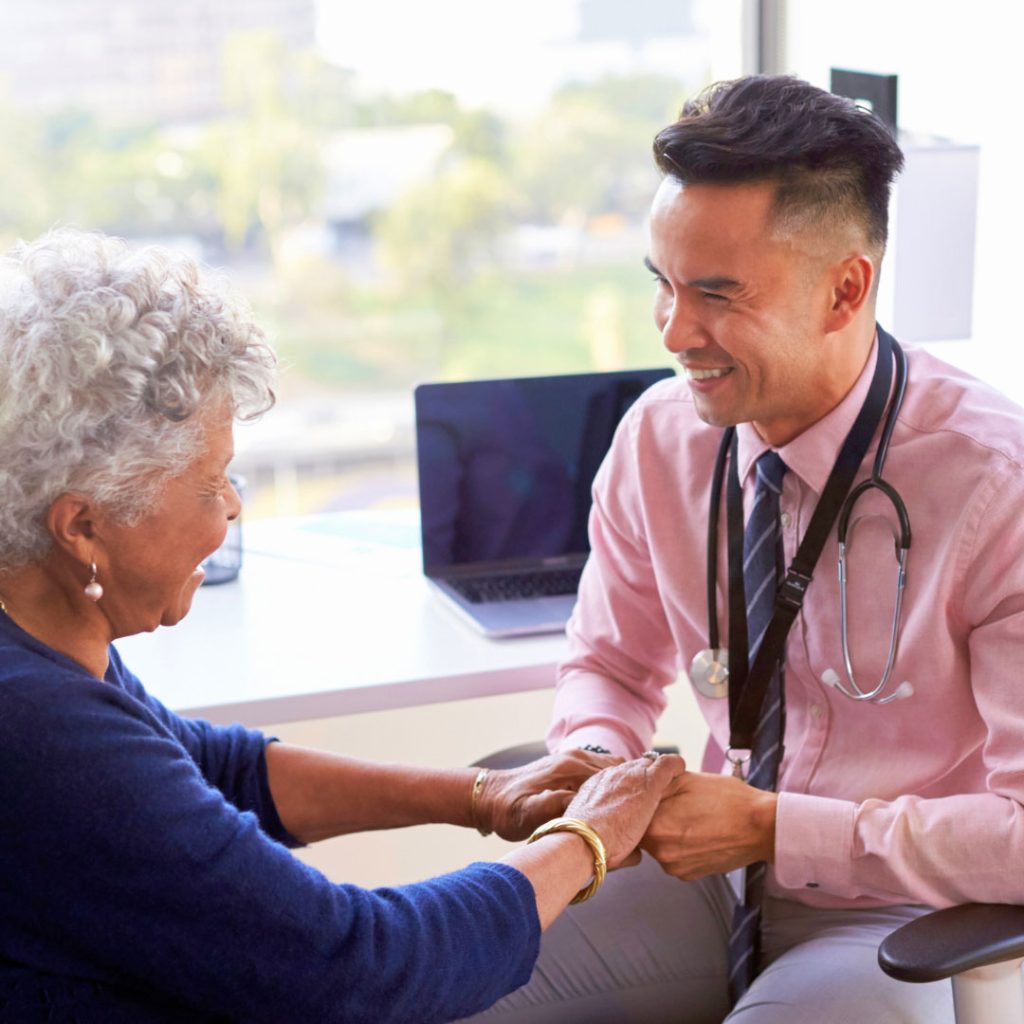 doctor holding patients hands