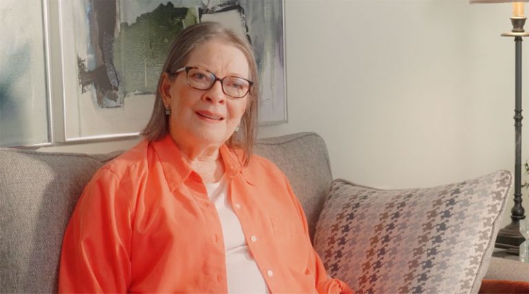 Smiling Woman in Orange Shirt