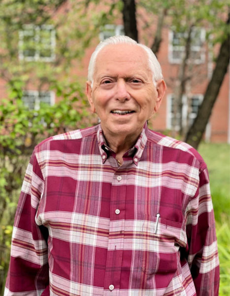 smiling man in red plaid shirt