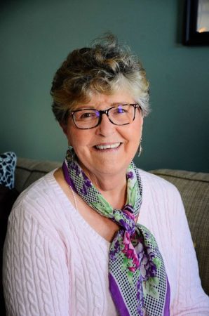 smiling woman with colorful neck scarf