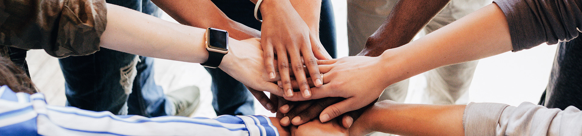 A group of people with their hands overlapped