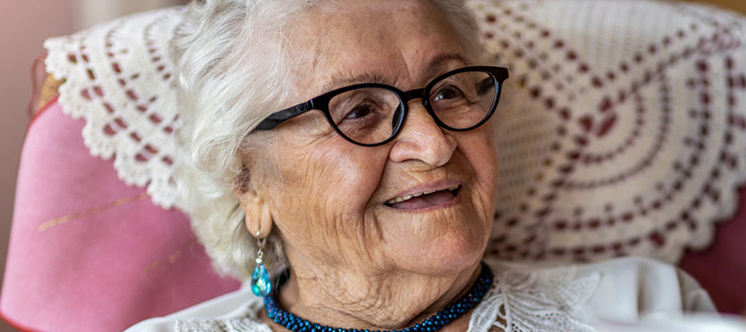 woman with glasses smiling