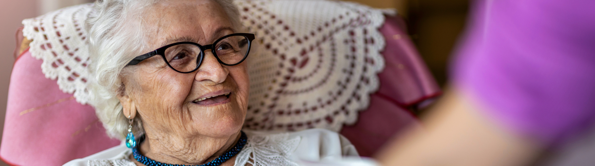 woman with glasses smiling