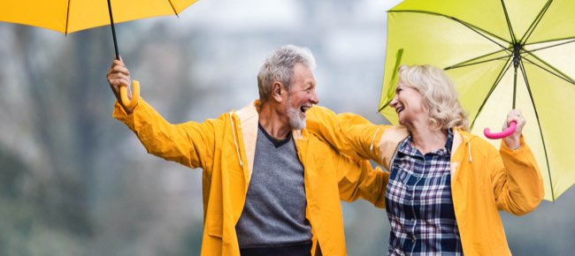 couple with umbrellas walking in the rain