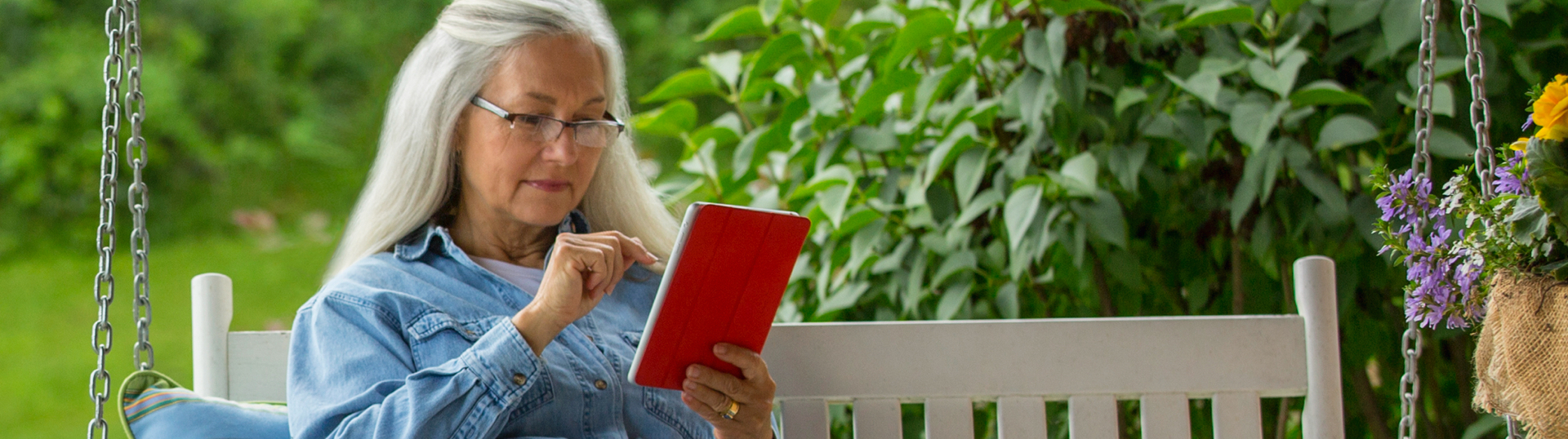 lady on bench on tablet