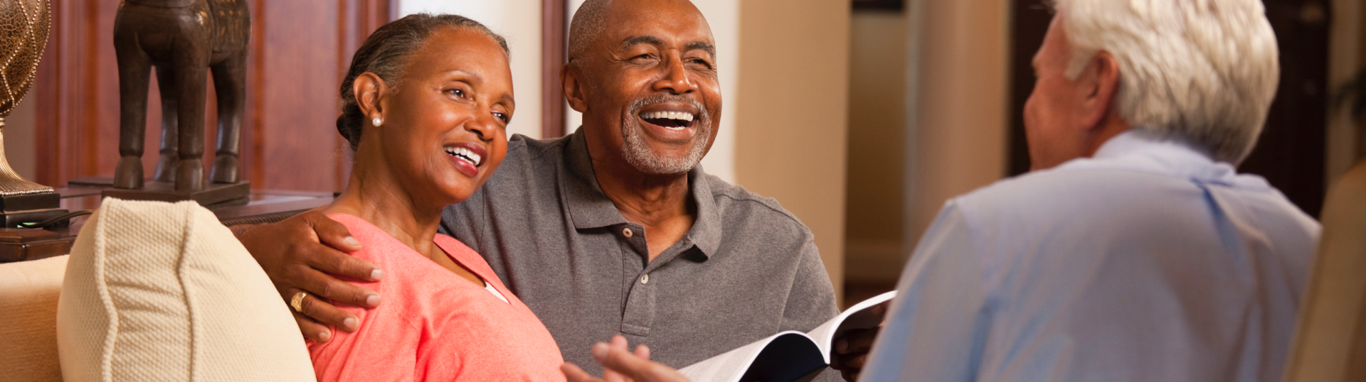 couple smiling talking to counselor