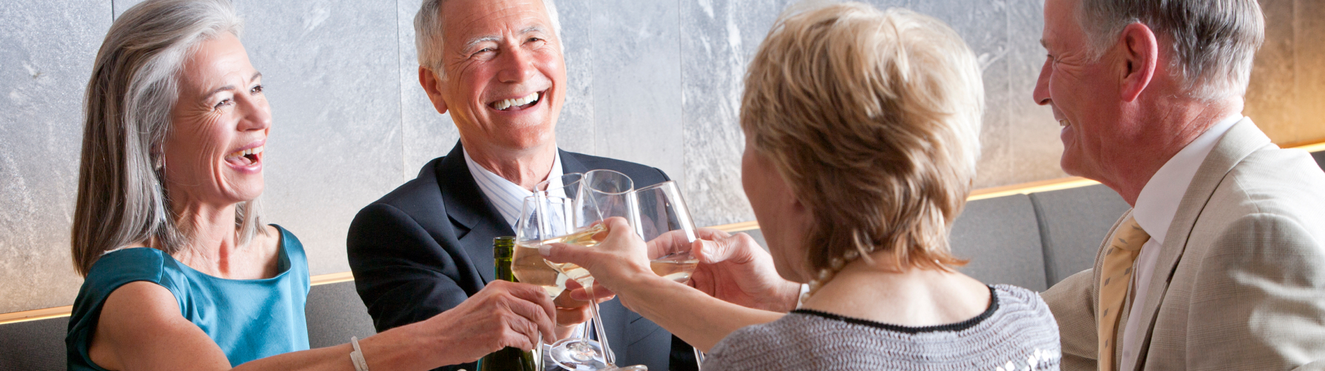 2 couples toasting & smiling