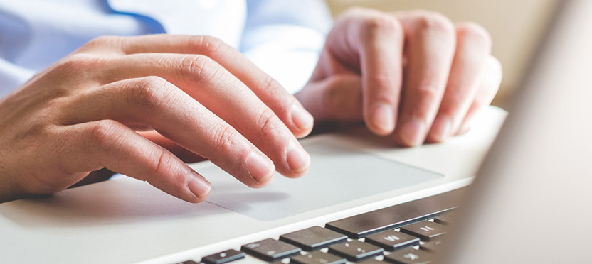 hands typing on laptop