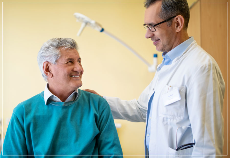 doctor talking to patient with hand on his back