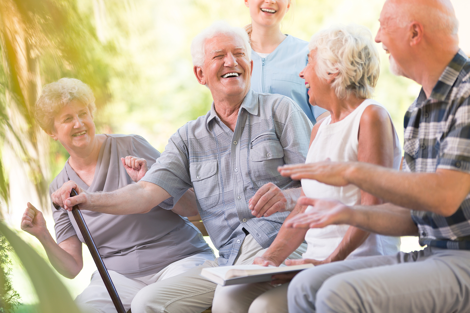 A group of seniors sit and laugh together.