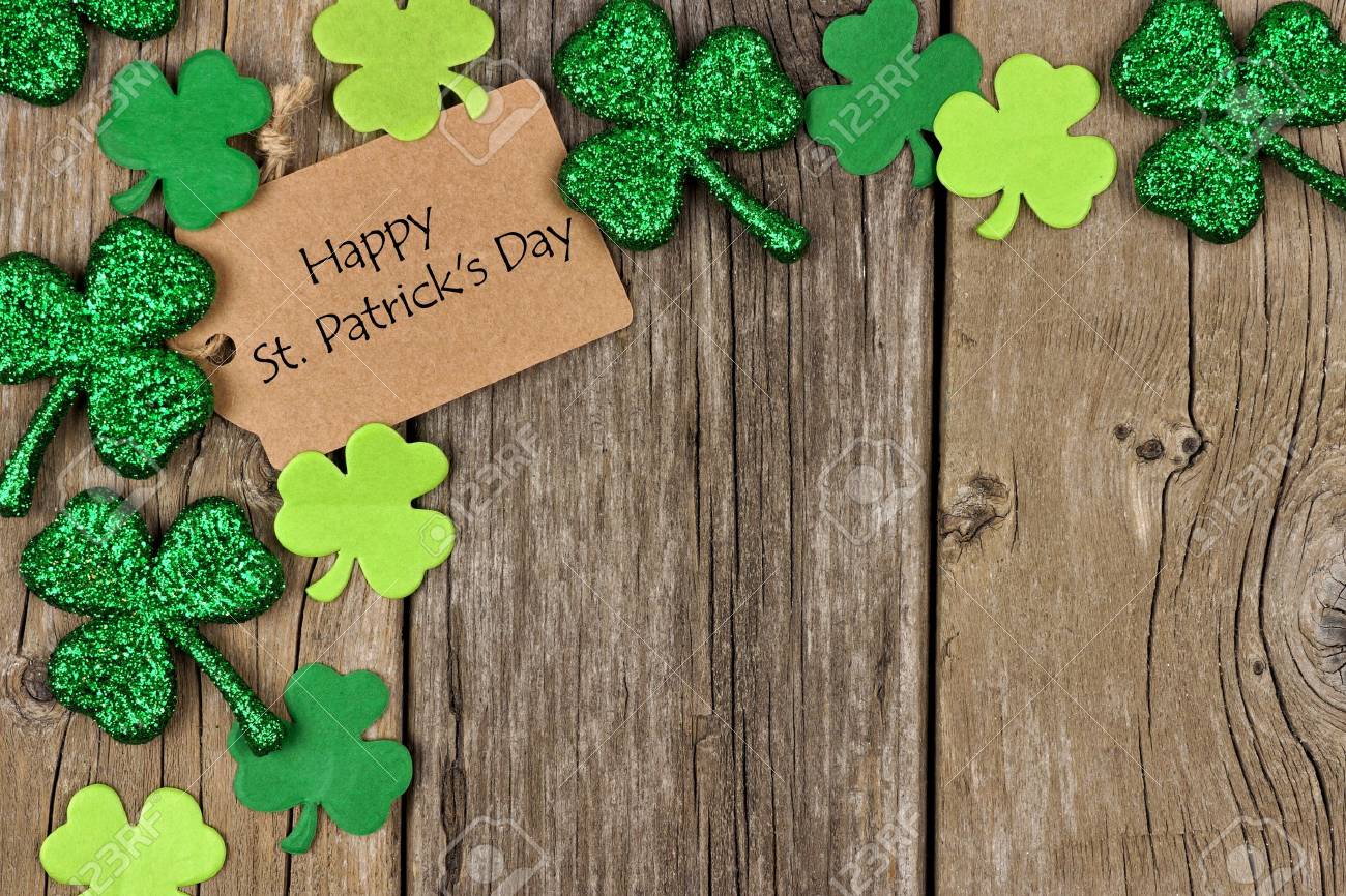 Happy St. Patrick's Day background with rustic wood and clovers.