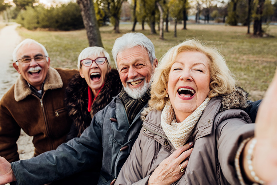 A group of seniors smile for a selfie.