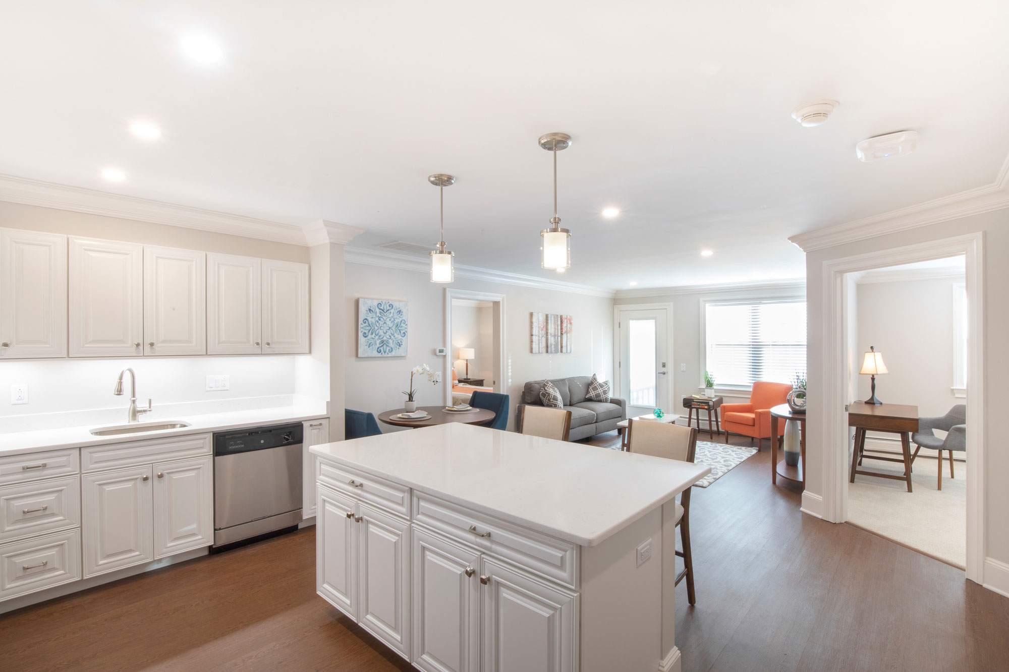 View of a kitchen and living room in a senior apartment at Fellowship Village.