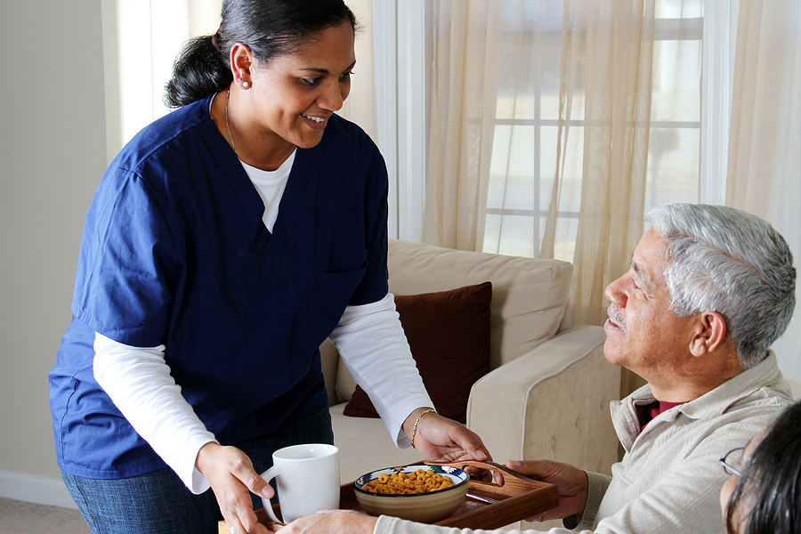 man receiving food from a nurse