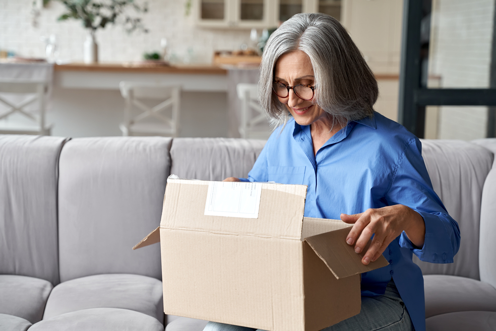 senior woman packing up a box