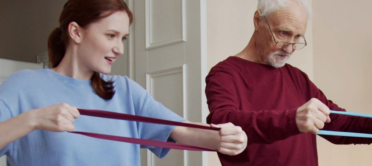 senior exercising with health care worker