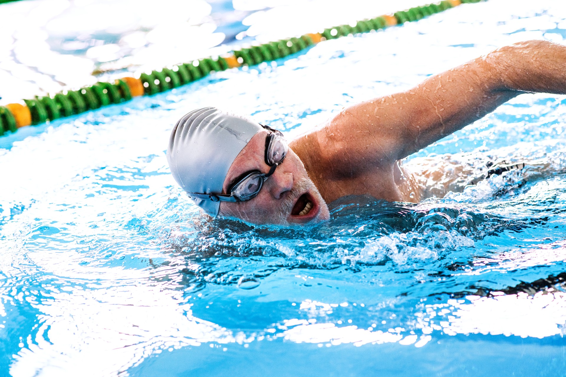 older adult man swimming